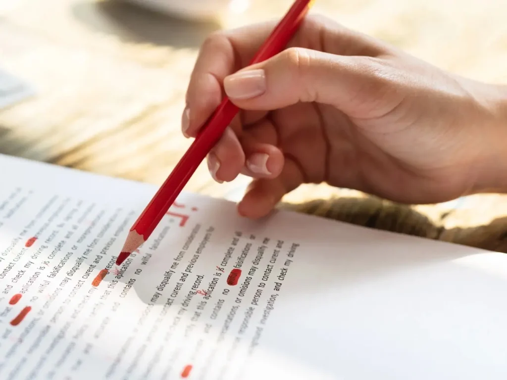 Manuscript proofreading process highlighting grammar and clarity edits